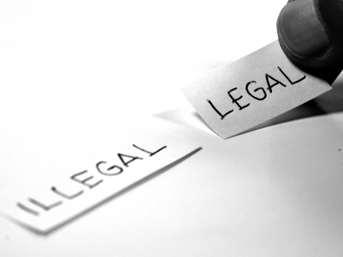 Illustration of a green book titled Anti-Homosexuality Act 2023 with a large question mark beside it
